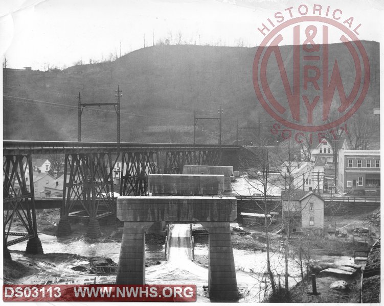 View of Cooper WV during construction of mainline bridge for Elkhorn realignment project. Old electrified bridge is on left. New concrete piers are center of image.