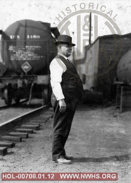 VGN unidentified man, location/date unknown with tank car in background