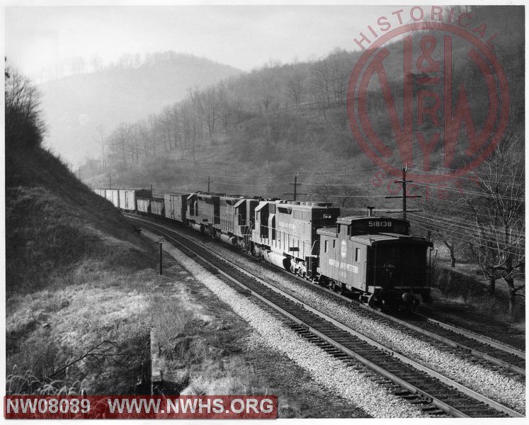 N&W eastbound time freight No. 86 is pushed by SD45 and two SD40 with caboose CF #518138 up Elkhorn mountain