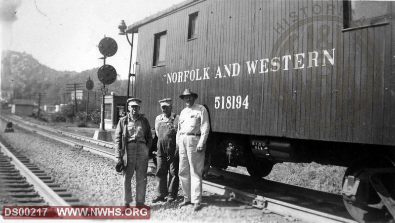 N&W Class CF caboose 518194 with men, Location unknown