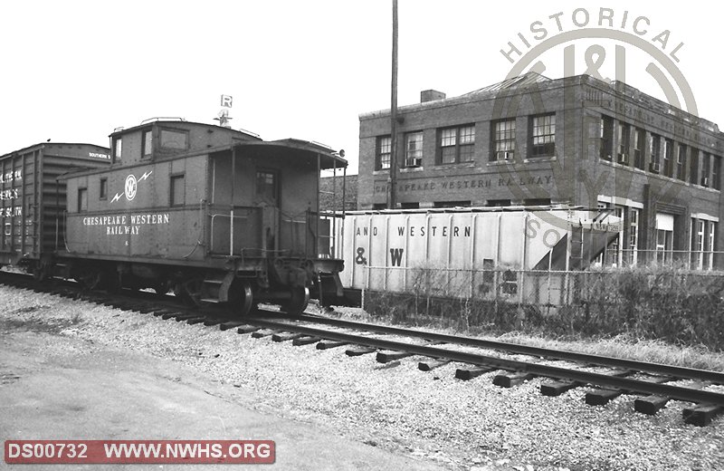 Caboose CW 6 in fromt of CW headquarters building in Harrisonburg VA. Partial view of NW 173299.