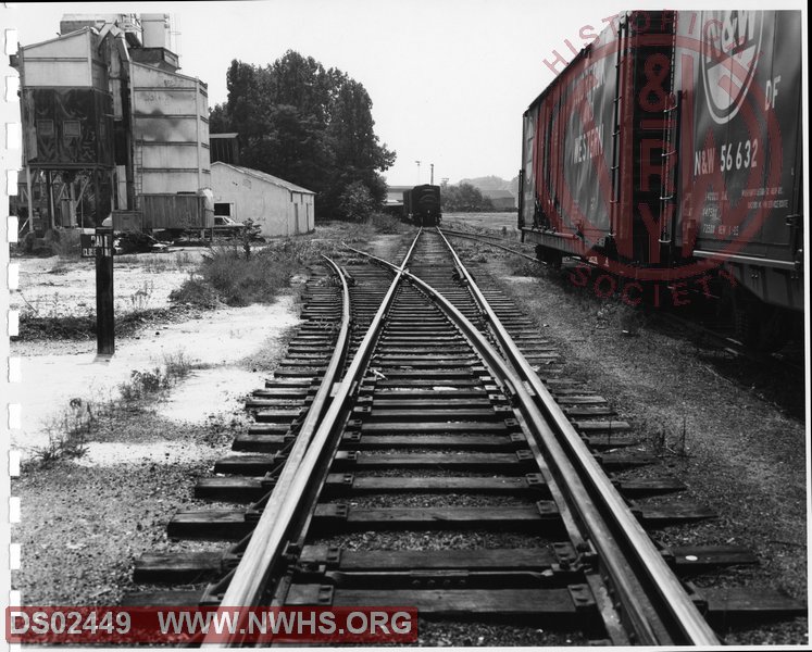 N&W: Radford yard:Main track Radford Branch showing track leading into Ready Mix Concrete and Radford Coal and Lumber Company, looking west.