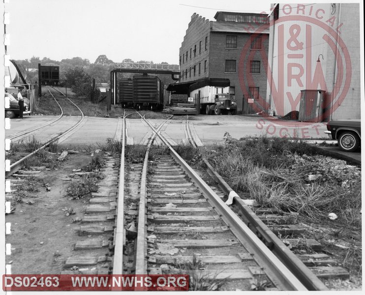 N&W: Pulaski yard:Looking East on Rolling Mill Spur showing State Route #99 Crossing and Coleman Furniture Plant No. 1, and Huff Coal and Oil Company Tipple.