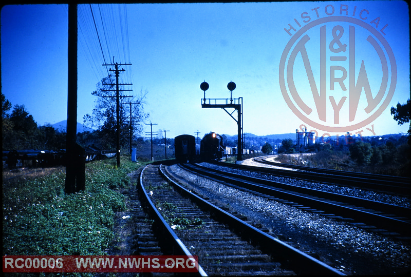 Image of two trains passing under a cantilever signal bridge at Tinker Creek Connection